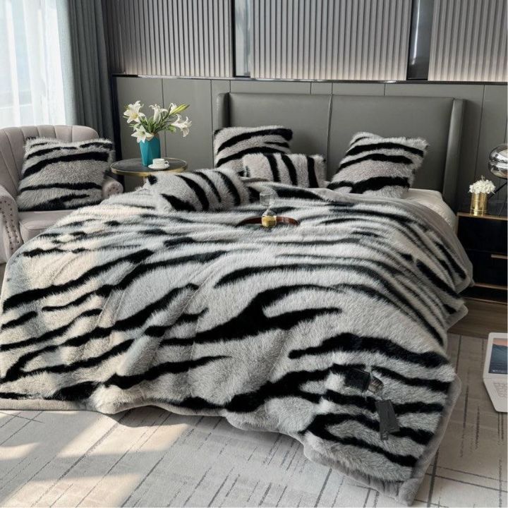 Zebra Print Faux Fur Blanket Set. Crafted with ultra-soft, high-density faux fur, this blanket brings a bold and exotic flair to your space with its striking black and white zebra pattern.