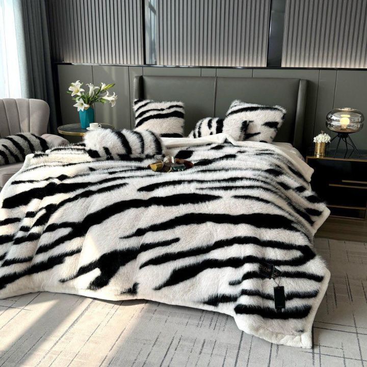 Zebra Print Faux Fur Blanket Set. Crafted with ultra-soft, high-density faux fur, this blanket brings a bold and exotic flair to your space with its striking black and white zebra pattern.