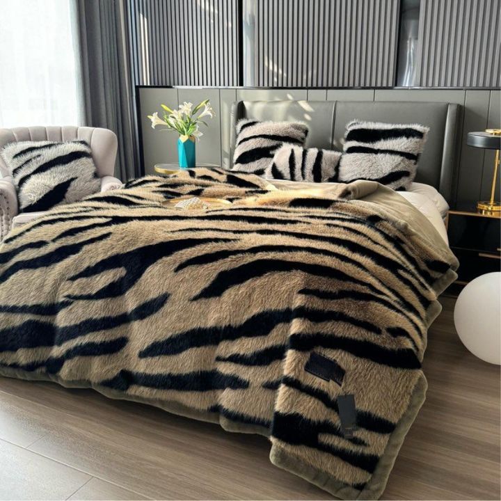 Zebra Print Faux Fur Blanket Set. Crafted with ultra-soft, high-density faux fur, this blanket brings a bold and exotic flair to your space with its striking black and white zebra pattern.