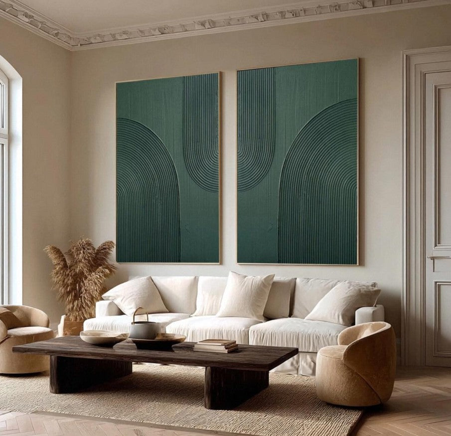 Modern living room with a white sofa, wooden coffee table, and abstract green wall art.