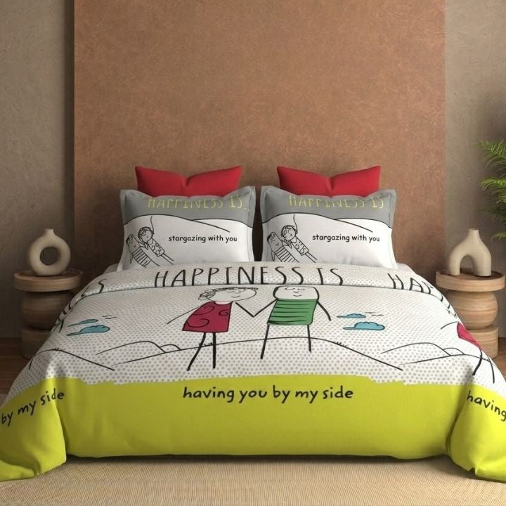Bedding set with 'Happiness is having you by my side' design on a bed with red and gray pillows.