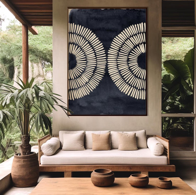 Modern interior with a wooden sofa, decorative wall art, and potted plants.