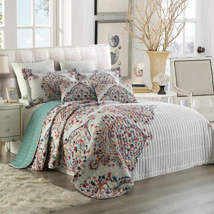 Bedroom with floral bedding and decorative pillows