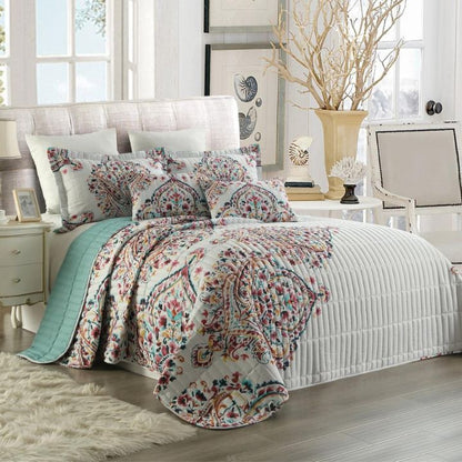 Bedroom with floral bedding and decorative pillows