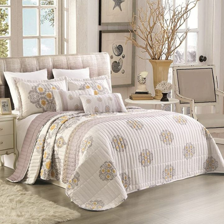Bedroom with floral-patterned bedding on a bed, side tables, and decor.