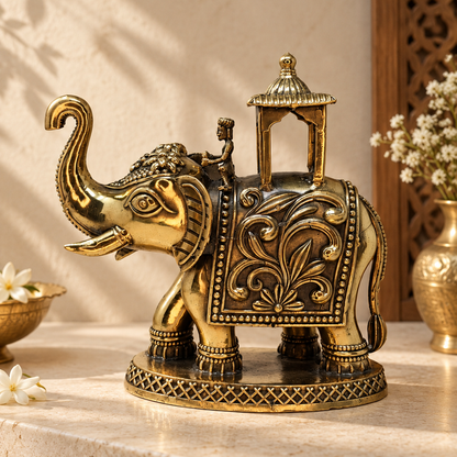 Antique brass Eravat elephant with ornate howdah, traditional brass pooja item featuring detailed craftsmanship and decorative design.