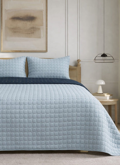 Soft and snug luxury 3-piece quilted bedding set by The Gharnish with reversible pastel bedspread and textured quilted design.