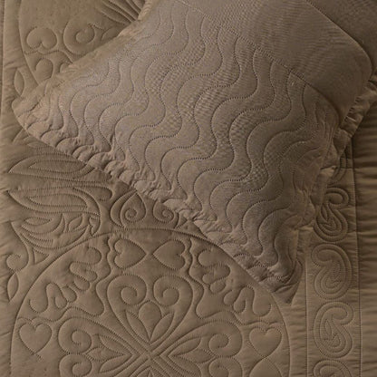 Close-up of a textured brown quilt with intricate patterns