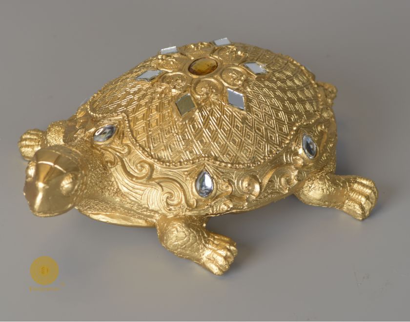 Gold tortoise animal figurine for Vastu, decorative showpiece from The Gharnish, showcasing intricate craftsmanship.