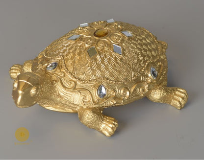 Gold tortoise animal figurine for Vastu, decorative showpiece from The Gharnish, showcasing intricate craftsmanship.