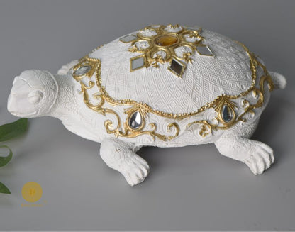 Gold tortoise animal figurine by The Gharnish, a Vastu showpiece symbolizing stability and good fortune.