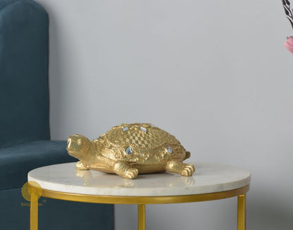 Gold tortoise animal figurine for Vastu, decorative showpiece from The Gharnish, featuring detailed craftsmanship.