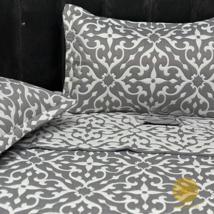 Cally Lilly Premium Quilted Bedding Set by The Gharnish features a floral pattern on soft, comfortable bedding for a cozy bedroom look.