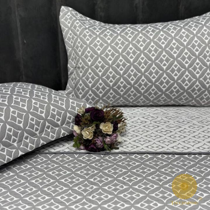 Cally Lilly Premium Quilted Bedding Set by The Gharnish featuring floral patterns and soft fabric for a cozy bedroom look.