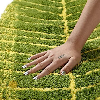 Banana leaf shape shaded doormat or bathmat made of carpet by The Gharnish, measuring 16x32 inches, with tropical leaf design.