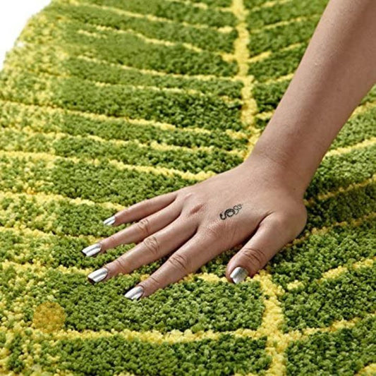 Banana leaf shape shaded doormat or bathmat made of carpet by The Gharnish, measuring 16x32 inches, with tropical leaf design.