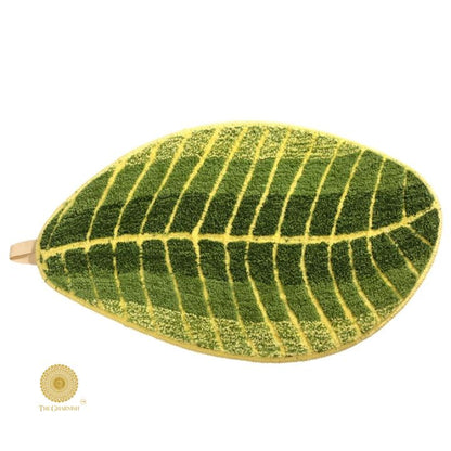 Banana leaf-shaped shaded doormat or bathmat made of carpet by The Gharnish, measuring 16x32 inches, with tropical leaf design.