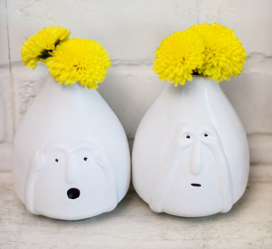 Set of two ceramic vases with facial feature designs by The Gharnish, showcasing artistic facial expressions in a decorative ceramic style.