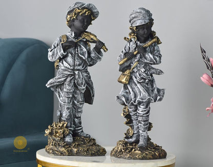 Abstract musical couple statue by The Gharnish, featuring elegant antique-style figurines in a stunning artistic design.