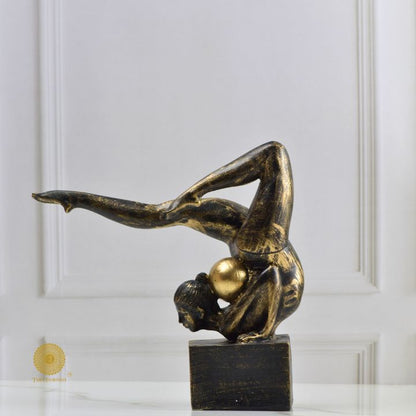 Ancient Gold Acribat gymnast figurine by The Gharnish, abstract gold sculpture of a gymnast in dynamic pose.