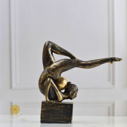 Ancient Gold Acribat Gymnast Figurine by The Gharnish, abstract sculpture depicting a gymnast in dynamic pose.