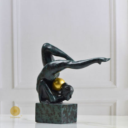 Ancient Gold Acribat Gymnast figurine by The Gharnish, an abstract gold sculpture of a gymnast in a dynamic pose.