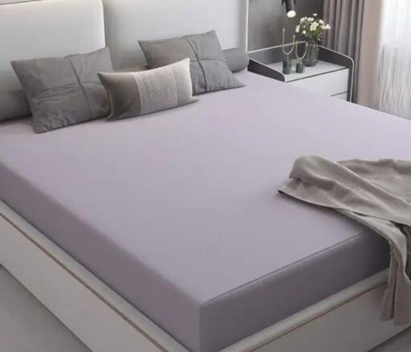 Premium quality Terry cotton waterproof mattress protector from The Gharnish, showing soft terry fabric and waterproof layer.
