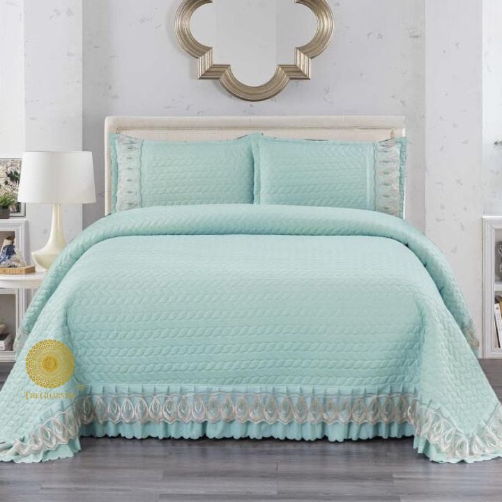 Astria Premium quilted and laced bedcover by The Gharnish, showcasing intricate quilting and elegant lace details on a bedding set.