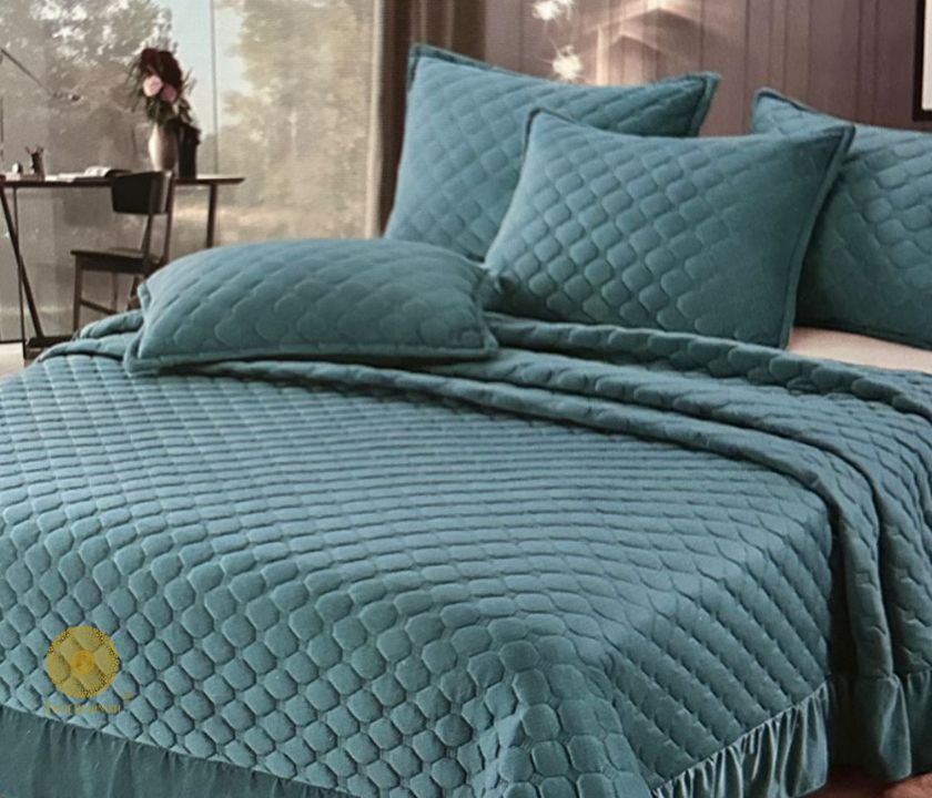 Velvet warm quilted bedcover set with frill detailing from The Gharnish, elegant bedding for a cozy bedroom look.