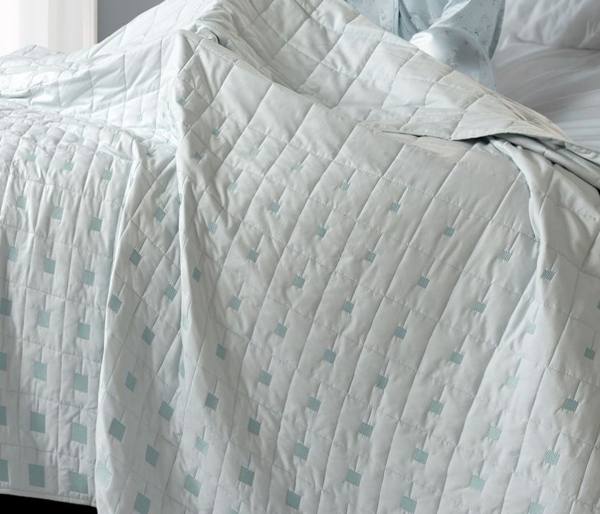 Luxury quilted bedding set by The Gharnish featuring six elegant, plush bedcovers with intricate quilting details.
