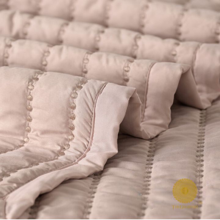 The Gharnish Moon Light designer quilted bedding set of 5 pieces with moon and light pattern, displayed on a bed.