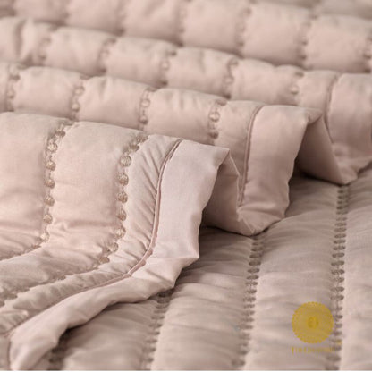 The Gharnish Moon Light designer quilted bedding set of 5 pieces with moon and light pattern, displayed on a bed.