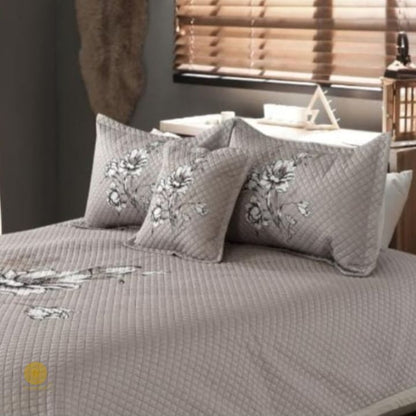 Premium quilted bedding 4-piece set by The Gharnish, featuring soft, textured fabric and matching pillow shams for a cozy bedroom look.