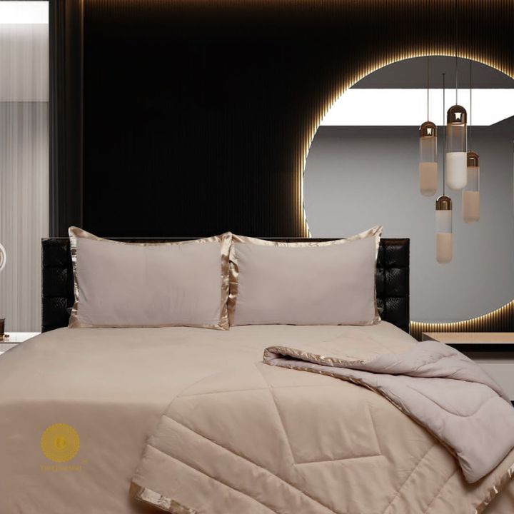Luxury reversible comforter set with satin border by The Gharnish, showcasing soft, plush bedding with elegant detailing.