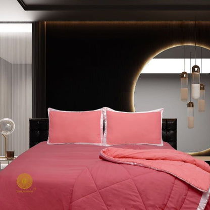 The Gharnish premium reversible comforter set with satin border, showcasing a stylish bedding design on a neatly made bed.