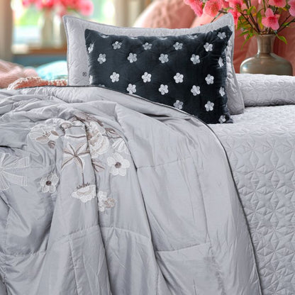 Set of five quilted bedding bedcovers with embroidered orchid design by The Gharnish, featuring elegant, decorative patterns.