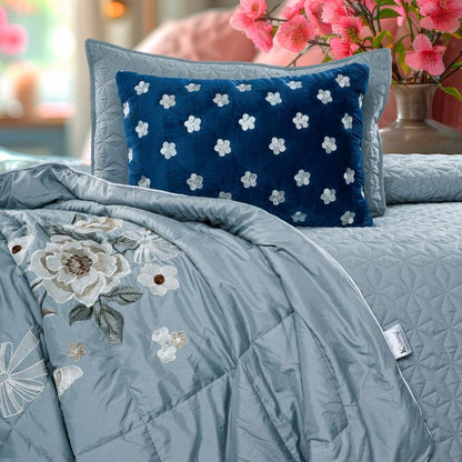 Set of five quilted bedcovers with intricate embroidery in orchid design by The Gharnish, showcasing elegant bedding style.