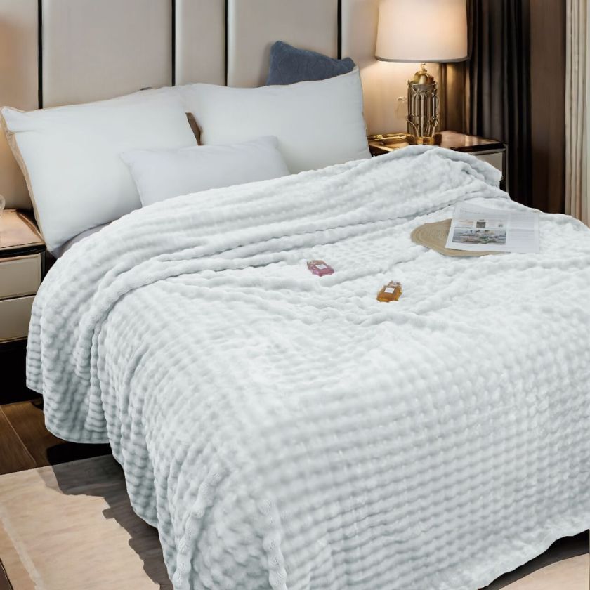 Super soft premium AC blanket by The Gharnish, showcasing cozy bedding with smooth, plush fabric in a neutral color.