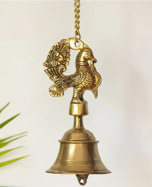 Brass peacock hanging etched bell, a traditional pooja item with intricate design, used in religious rituals and decorations.