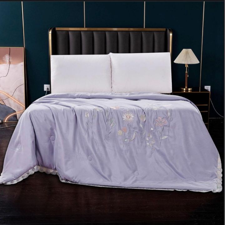 Luxury solid comforter with intricate embroidery from The Gharnish, perfect for summer collection bedding.