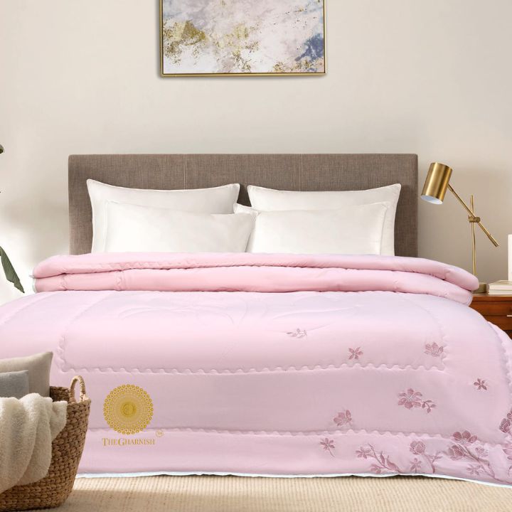 Elegant Comforter by The Gharnish featuring intricate embroidery, showcasing a luxurious and stylish bedding accessory.