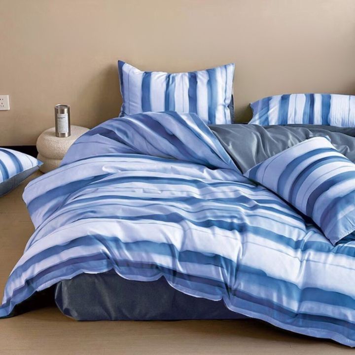 The Gharnish Palette Stripe 4-piece comforter set with a modern striped design on a bed, including comforter and matching pillow shams.