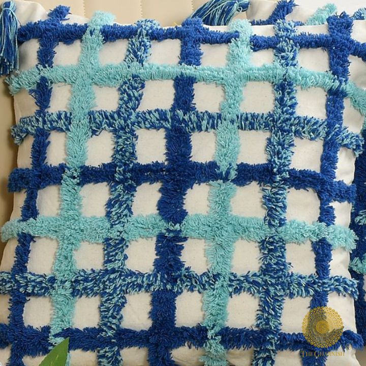 Set of two soft white and blue tassel cushions by The Gharnish, 16x16 inches, featuring decorative tassels and plush fabric.