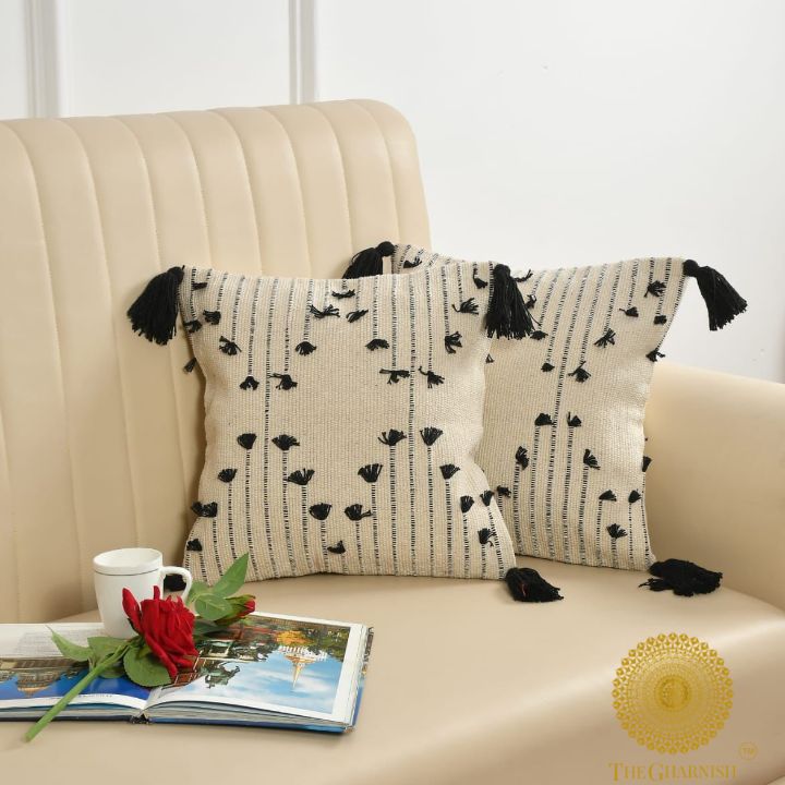 Set of two handcrafted cushion covers with tassels from The Gharnish, 16x16 inches, featuring stylish, textured fabric.