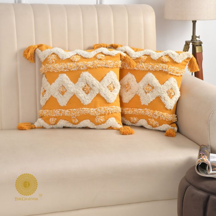 Set of two hand-embroidered cotton sofa cushion covers by The Gharnish, featuring intricate designs and soft fabric.