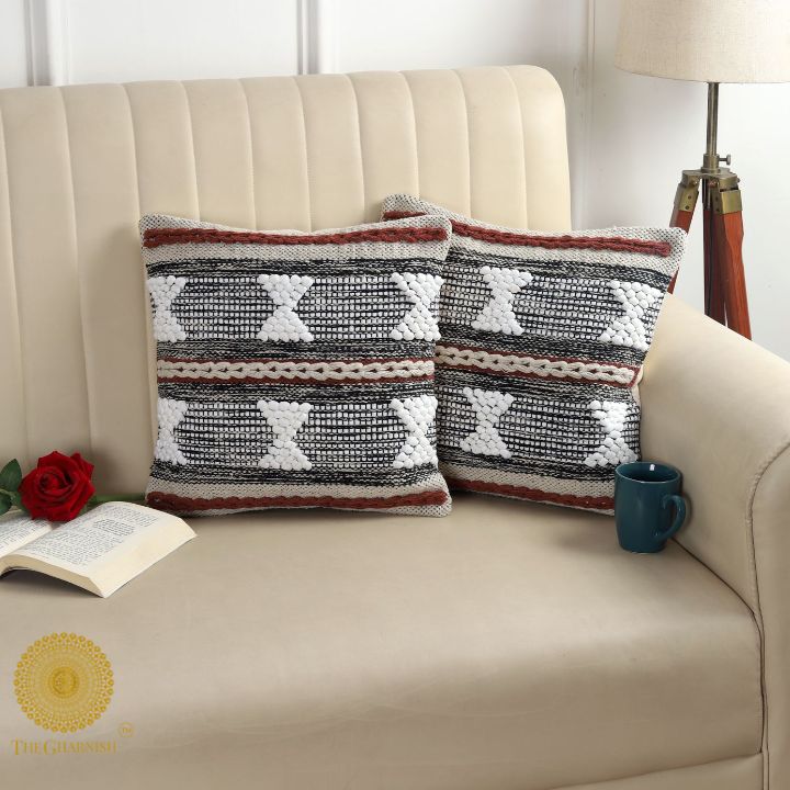 Set of two handcrafted thread work cushion covers by The Gharnish, featuring intricate embroidery and textile design.