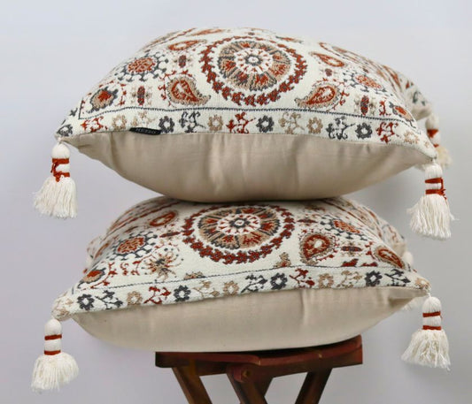 Pure cotton Hanblocked cushion cover with tussels from The Gharnish, featuring intricate patterns and decorative tassels.