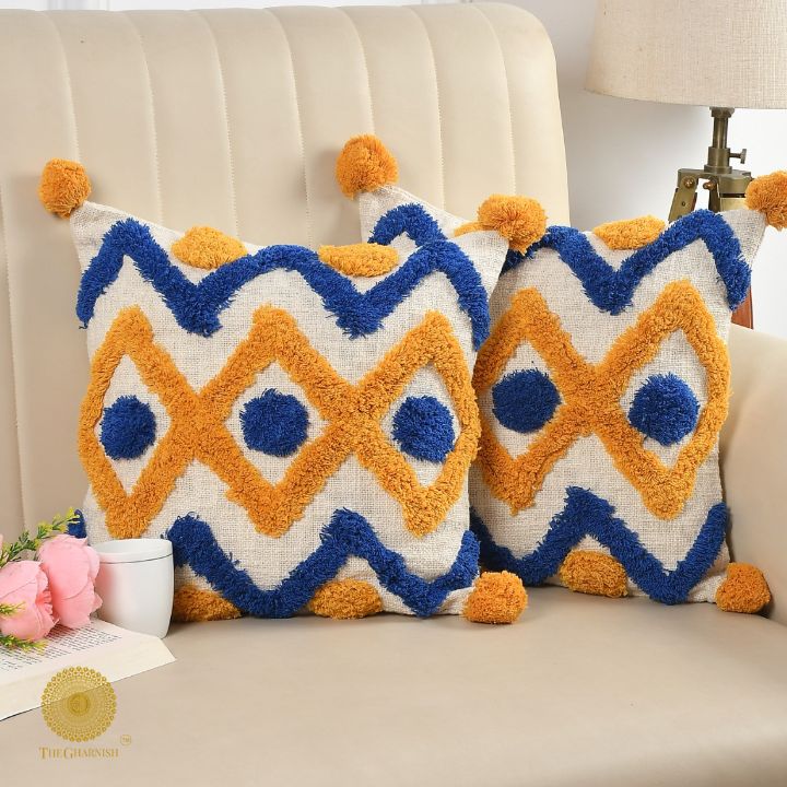 Set of 2 mustard tufted cushion covers with tassels from The Gharnish, featuring cozy, decorative designs for home decor.