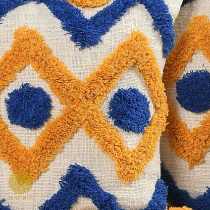 Set of 2 mustard tufted cushion covers with tassels by The Gharnish, featuring textured fabric and decorative tassel accents.