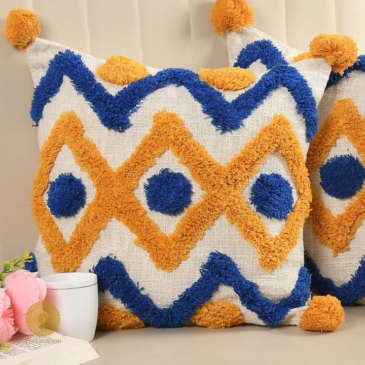 Set of 2 mustard tufted cushion covers with tassels by The Gharnish, featuring soft fabric and decorative tassel accents.